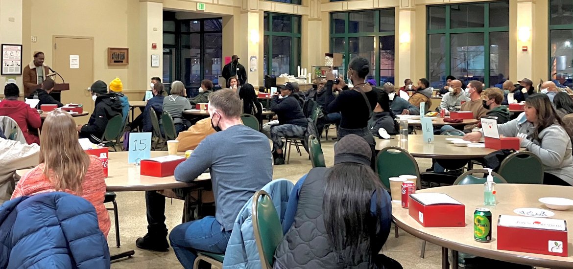 2023 PIT Count volunteers eat dinner and listen to speakers before canvassing the City